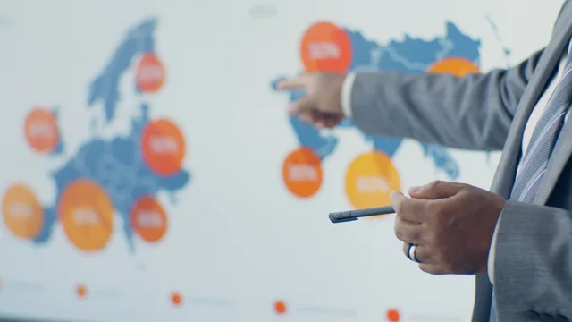 Professional presenting detailed analytics on European map during office meeting. Attribution skills planned from the work, not from imagined headcount